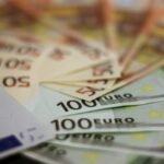 Close-up of various euro banknotes fanned out, symbolizing wealth and financial success.